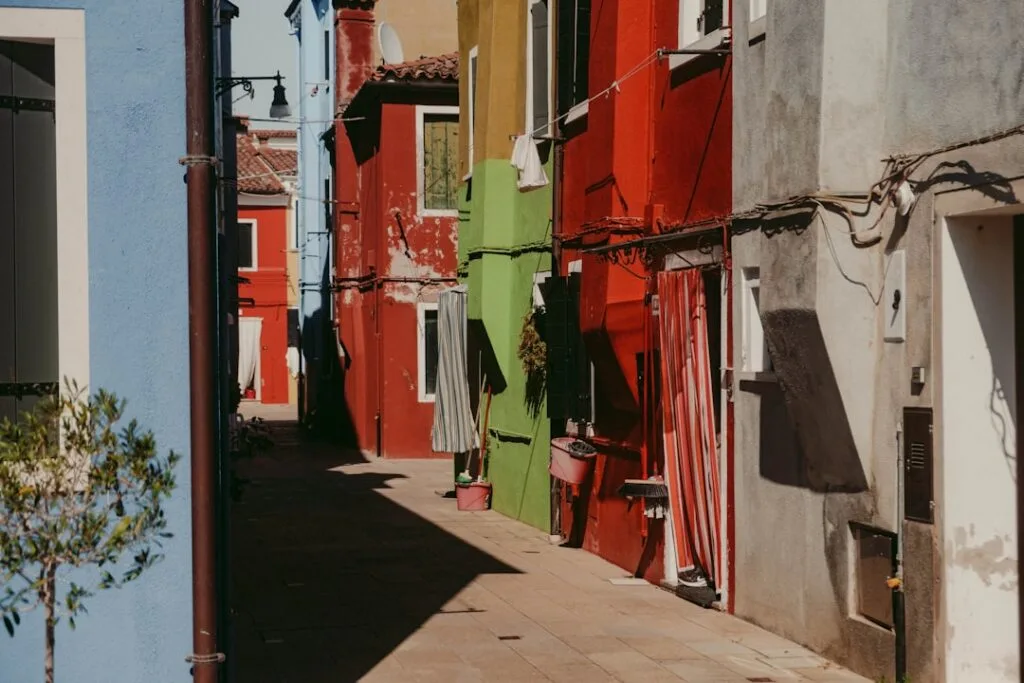 Sonnige enge Gasse mit bunten Häusern auf Burano