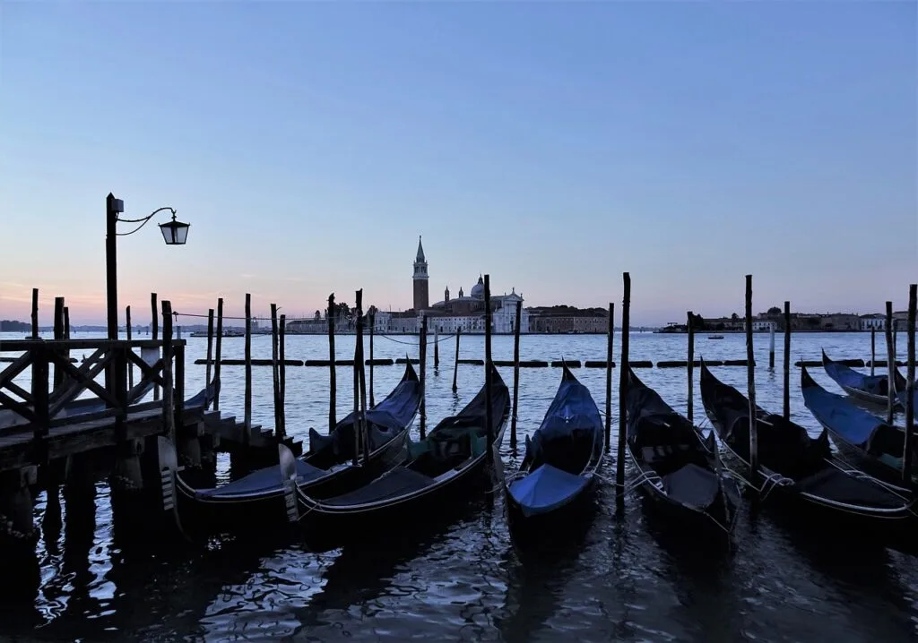 Gondoles amarrées en silhouette devant San Giorgio Maggiore à Venise.