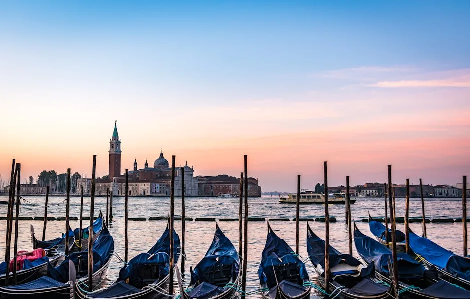 Gondolas moored facing the island of San Giorgio Maggiore in Venice at sunset