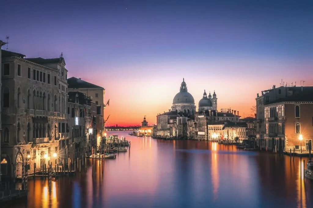 Sunset over Venice Grand Canal with Basilica di Santa Maria della Salute silhouette.