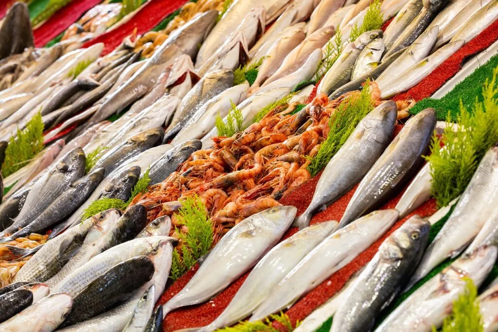 Fresh seafood display at Venice market with fish and shrimp.